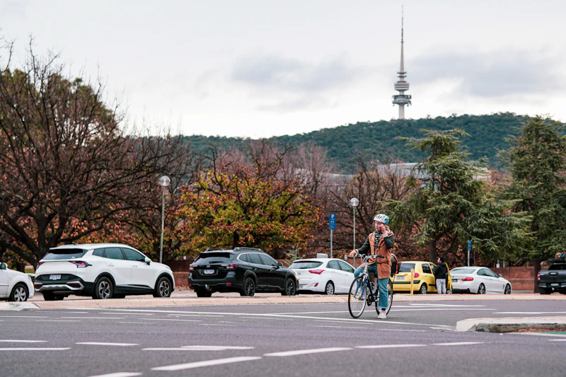 A person riding a bike across a street