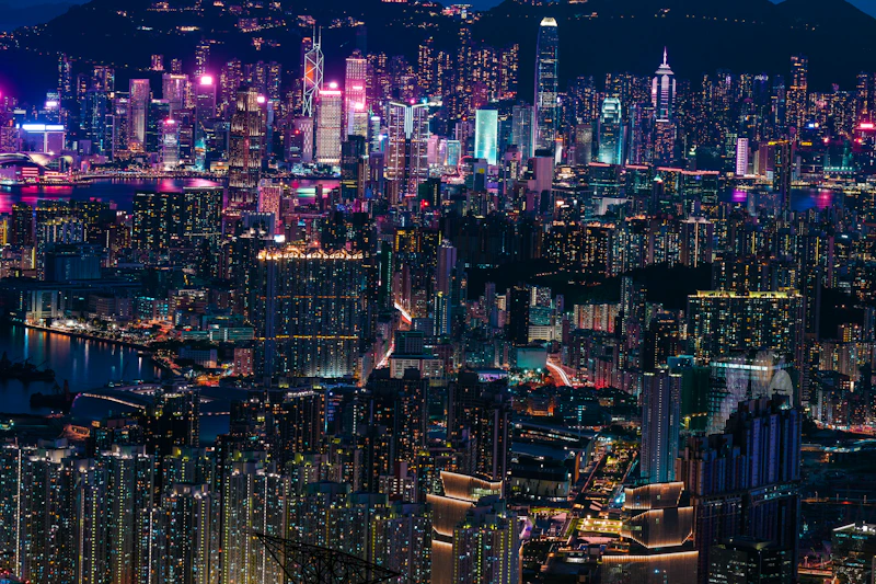 A view of a city at night with a mountain in the background