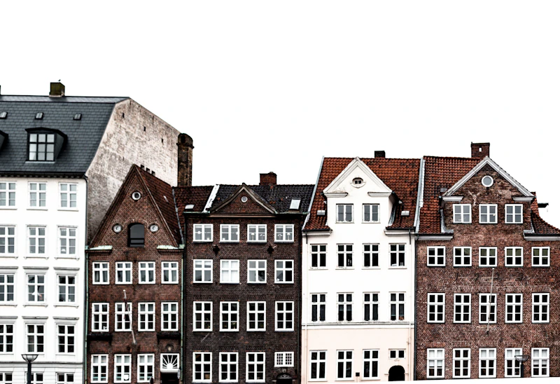 a row of buildings with a clock on each of them