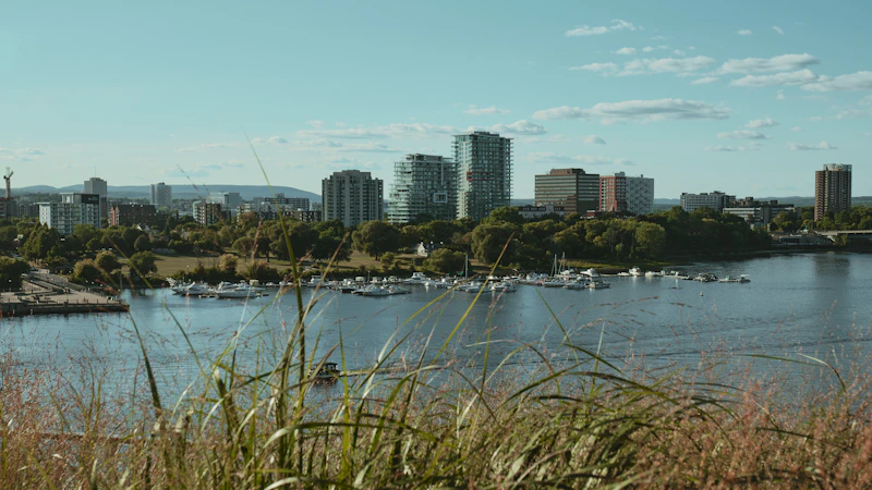 City skyline with boats docked on the river.