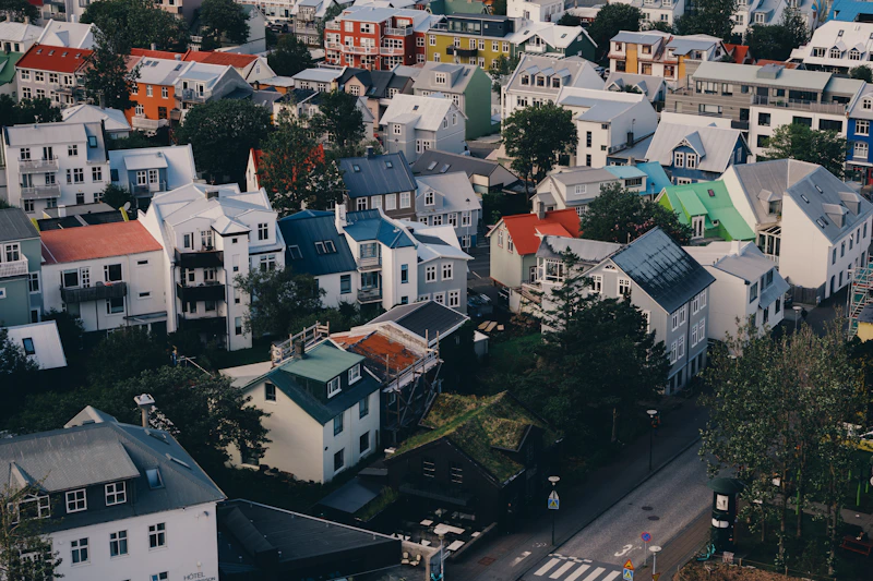 Colorful houses nestled on a hillside in a city.