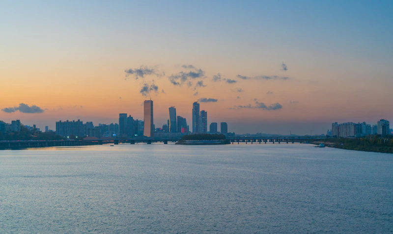 a large body of water with a city in the background