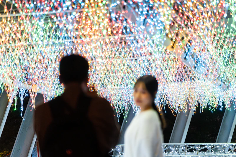 Two people silhouetted against colorful bokeh lights