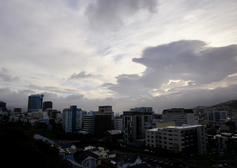 City skyline under a cloudy sky at dusk