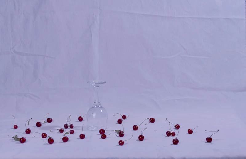 a vase with red berries